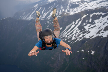 Skydivers over snowy mountains in Norway