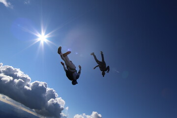 Skydivers over snowy mountains in Norway