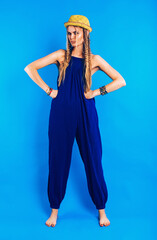 serious funny woman in blue jumpsuit and straw hat