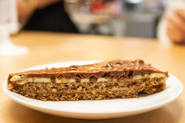 Delicious caramel and chocolate layered cracker toffee on table.