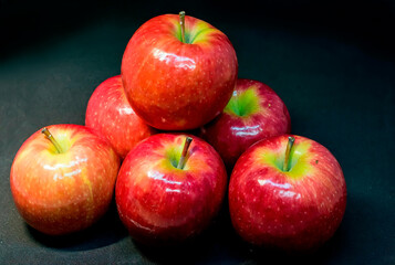 Fresh red apples isolated on dark background