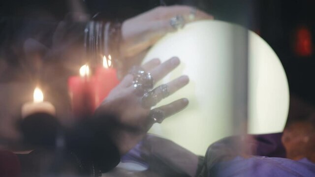 Close up of tarantula in aquarium and seer using crystal ball on background