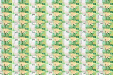 200 russian rubles bills printed in money production conveyor. Collage of many bills. Concept of...