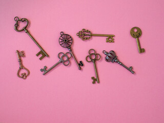 Many different old keys from different locks, scattered chaotically, flat lay.