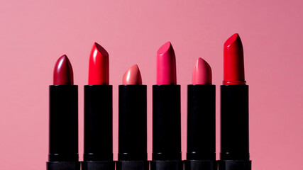 assortment of six multi-colored lipsticks or lip glosses. set for bright lip makeup,