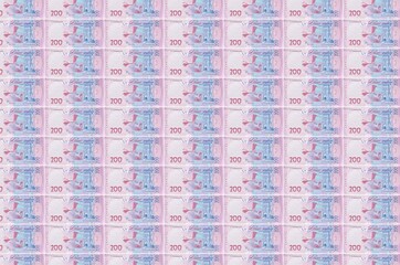200 Ukrainian hryvnias bills printed in money production conveyor. Collage of many bills. Concept...