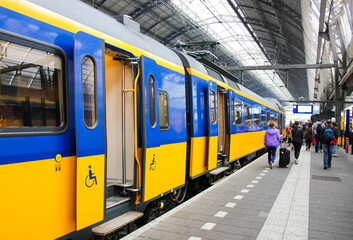 Entrance door to the train carriage for wheelchairs. Facilities in the public areas of the cripple. Front door with disabled sign on train platform.  Disabled people travel.
