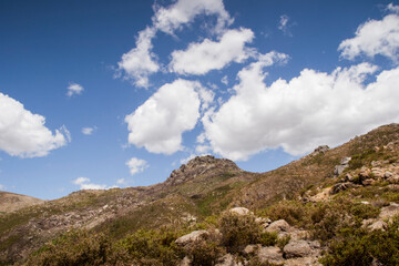 Fototapeta na wymiar Mountain peak uphill under blue sky