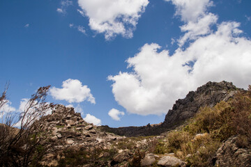 Mountain peak uphill under cloudy sky
