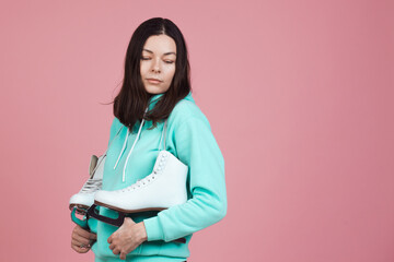 Figure skating for adults, Hobbies and a healthy lifestyle. A young woman in a bright sweatshirt...