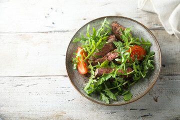 Arugula salad with grilled beef steak
