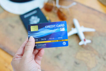 Hand with credit card, concept of using credit card for tourism