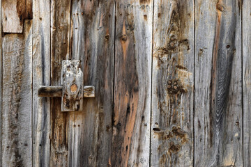 Rural style wood texture of an old door with crossbar closure