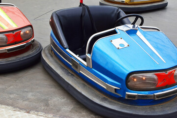 Plakat Old empty electric bumper cars in autodrom in fairground attractions at amusement park. 
