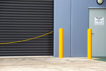 Warehouse dispatch with closed roller door and yellow safety chain