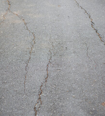 Obraz premium Cracks on the concrete road surface. Outdoor locations.