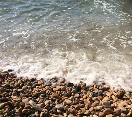 Stone shore of the Black Sea, background. Exciting sea wave. Rest on the shore of the reservoir. Photo without people.