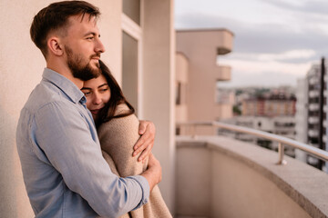 Close up portrait, man and woman smiling to each other on sunset with city in background. Couple romantic intimate moments