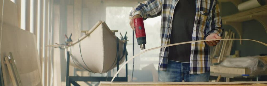 CU Portrait Of Caucasian Male Building A Canoe In His Workshop. Boat Making Hobby, Small Business Owner