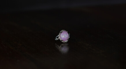 Opal is a silver ring decorated with an opal gem.