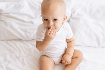 baby boy on white bed
