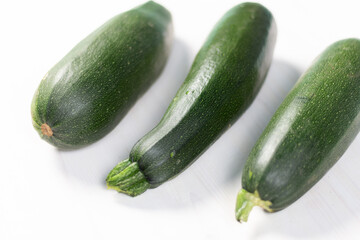 Green zucchini marrows on white background