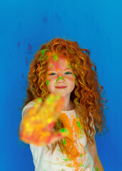 red-haired girl in holi paints