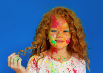 red-haired girl in holi paints