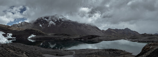 Moody panorama landscape of mountains and lagoon in Nevado Pastoruri, Huaraz, Peru