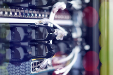 Hosting platform for modern Internet resources. Rack with server data storage equipment. Many network cables are connected to the data center equipment
