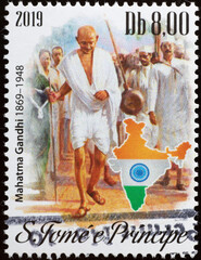 Gandhi surrounded by people on postage stamp