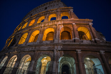 The monumental Colosseum at night, the largest oval Amphitheatre built by the Flavian dynasty in the centre of Rome, just east of the Roman Forum, an iconic symbol of the Roman Empire, Rome, Italy.