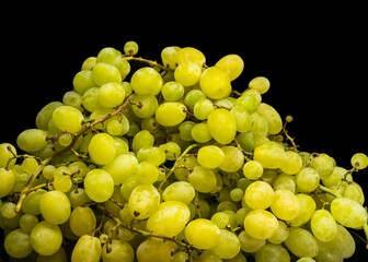 Sweet green grapes on a black background