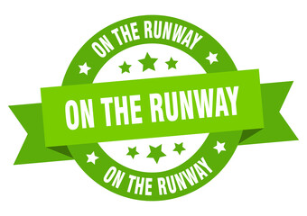 on the runway round ribbon isolated label. on the runway sign