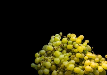 Sweet green grapes on a black background