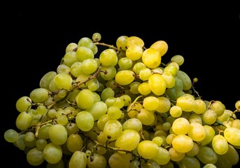 Sweet green grapes on a black background