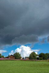Naklejka na ściany i meble rural landscape with barn and clouds, åre, jämtland, sverige