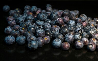 Blueberries scattered on a dark background