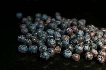 Blueberries scattered on a dark background