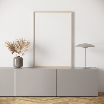 3d render of a modern mockup interior with wooden frame on a greey sideboard and a ceramic vase with fan palm