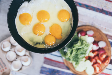 Breakfast flat lay of fried eggs and vegetables