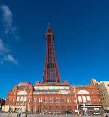 Blackpool seafront and promenade with a blue cloudless sky including the Blackpool Tower, Lancashire, UK