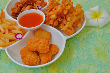 Yummy appetizer with chili sauce cup in white tray