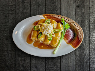 Fresh spring rolls on black wooden table