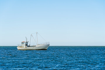 Old Traditional for baltic sea or scandinavian countries Vintage fishing boat in sea. minimalist shot.