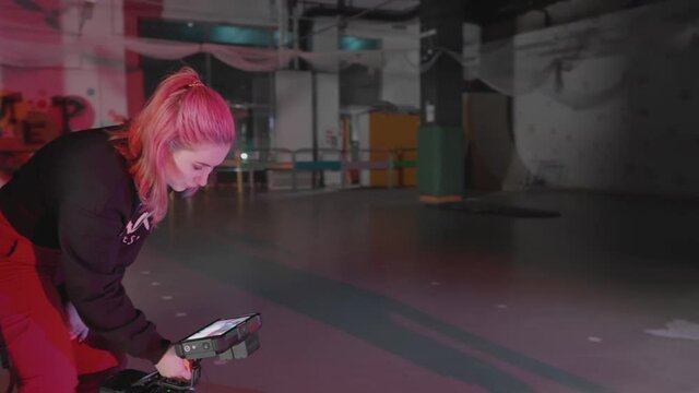 Young male showing impressive skills of rollerskating. Teenager riding around obstacles, dancing around and friend recording on camera. Concept of millennials in alternative pop culture lifestyle.