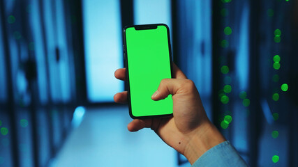 Close-up male engineer working in database with modern smartphone application. IT tech admin using...