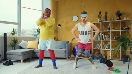 Sports parody. Comical funny unfit retro looking young men training with resistance bands doing...