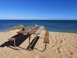 Ideally located table with views of a remote beach