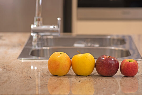 Four Australian grown pear and apples on the kitchen table -Pear Papple - Apple Yello - Bravo apple - Pink lady apple